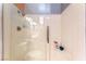 Bathroom shower featuring glass doors, shower head, and built-in shelving at 2732 Johannson Ln, Las Vegas, NV 89115