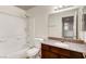 Bathroom featuring a granite countertop, wood vanity, and tiled shower at 2801 N Rainbow Blvd # 102, Las Vegas, NV 89108
