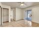 Well-lit bedroom featuring tile floors, a ceiling fan, and sliding glass doors to the outside patio at 2801 N Rainbow Blvd # 102, Las Vegas, NV 89108