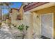 Inviting entrance with security door, landscaped grounds, and stucco exterior in a residential building at 2801 N Rainbow Blvd # 102, Las Vegas, NV 89108