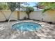 Private hot tub surrounded by lush landscaping and a privacy fence at 2801 N Rainbow Blvd # 102, Las Vegas, NV 89108