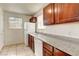Efficient kitchen with granite counters, wood cabinets, and a white appliance package at 2801 N Rainbow Blvd # 102, Las Vegas, NV 89108