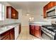 This kitchen features granite counters, stainless range, dishwasher, and dark wood cabinets at 2801 N Rainbow Blvd # 102, Las Vegas, NV 89108