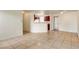 Living room seamlessly transitions into the dining and kitchen area, featuring tile flooring and a breakfast bar at 2801 N Rainbow Blvd # 102, Las Vegas, NV 89108