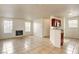 Bright living room features a fireplace and tile flooring, connecting to a kitchen bar area at 2801 N Rainbow Blvd # 102, Las Vegas, NV 89108