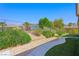 Beautifully landscaped backyard with manicured lawn, and desert scenery at 2962 Gettysburg Ave, Henderson, NV 89052