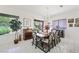 This dining room features a modern light fixture, large windows, and a large dining table at 2962 Gettysburg Ave, Henderson, NV 89052