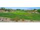 Scenic golf course view with lush green fairways and sand traps, set against a backdrop of distant mountains at 2962 Gettysburg Ave, Henderson, NV 89052
