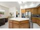 Another view of the kitchen with an island, stainless appliances and light wood cabinetry at 2962 Gettysburg Ave, Henderson, NV 89052