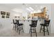 Bright kitchen bar area has a skylight and stylish black stools perfect for entertaining at 2962 Gettysburg Ave, Henderson, NV 89052