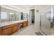 Bright bathroom featuring double sinks, an enclosed glass shower, and access to a walk-in closet at 2962 Gettysburg Ave, Henderson, NV 89052