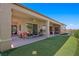Large covered patio featuring a putting green, outdoor seating, and sliding glass door at 2962 Gettysburg Ave, Henderson, NV 89052