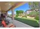 Spacious covered patio with outdoor seating, a putting green, and lush landscaping at 2962 Gettysburg Ave, Henderson, NV 89052