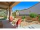 Inviting covered patio with seating area and landscaped backyard, perfect for outdoor relaxation at 2962 Gettysburg Ave, Henderson, NV 89052