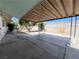 Spacious backyard with concrete patio, block wall and tree at 30 Diamond Cir, Las Vegas, NV 89106