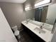 Modern bathroom with dual sinks, quartz countertops, a vanity and updated fixtures at 30 Diamond Cir, Las Vegas, NV 89106