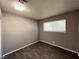 Cozy bedroom with wood-look flooring, neutral paint, and a window offering ample natural light at 30 Diamond Cir, Las Vegas, NV 89106