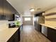 Modern kitchen with stainless steel appliances, dark cabinetry and tile backsplash with open shelving at 30 Diamond Cir, Las Vegas, NV 89106