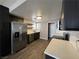 Bright, updated kitchen with stainless steel refrigerator, dark cabinets and subway tile backsplash at 30 Diamond Cir, Las Vegas, NV 89106