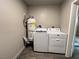 Convenient laundry area with modern washer, dryer, and water heater in a compact space at 30 Diamond Cir, Las Vegas, NV 89106