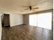 Light-filled living room with wood-look flooring and sliding glass doors, creating a welcoming atmosphere at 30 Diamond Cir, Las Vegas, NV 89106