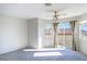 Bright and airy bedroom with neutral carpet, ceiling fan, and sliding glass doors to balcony at 3000 Waterview Dr, Las Vegas, NV 89117