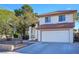 Charming two-story home featuring a well-manicured front yard and a two-car garage at 3000 Waterview Dr, Las Vegas, NV 89117