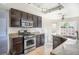 Modern kitchen features stainless steel appliances, granite countertops, and dark wood cabinetry at 3000 Waterview Dr, Las Vegas, NV 89117