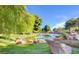 Lush green landscape featuring a serene pond with decorative rocks creates a relaxing environment at 3000 Waterview Dr, Las Vegas, NV 89117