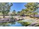 Community pond and mature landscaping with a small waterfall and decorative rocks create a peaceful environment at 3000 Waterview Dr, Las Vegas, NV 89117