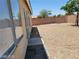 Gravel backyard featuring a brick wall and privacy at 3012 Silver Canyon Ln, North Las Vegas, NV 89031