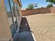 Gravel backyard featuring a brick wall and privacy at 3012 Silver Canyon Ln, North Las Vegas, NV 89031