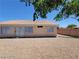 Backyard view with desert landscaping and a partial view of a shade tree at 3012 Silver Canyon Ln, North Las Vegas, NV 89031