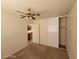 This bedroom has neutral paint and carpet and a ceiling fan with lights at 3012 Silver Canyon Ln, North Las Vegas, NV 89031