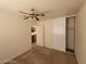 This bedroom has neutral paint and carpet and a ceiling fan with lights at 3012 Silver Canyon Ln, North Las Vegas, NV 89031