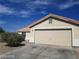 Exterior shot featuring a two car garage and blue skies at 3012 Silver Canyon Ln, North Las Vegas, NV 89031