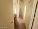 Hallway with neutral walls and doors leading to various rooms at 3012 Silver Canyon Ln, North Las Vegas, NV 89031