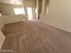 Open-concept living room featuring neutral walls and flooring at 3012 Silver Canyon Ln, North Las Vegas, NV 89031