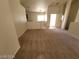 Open-concept living room featuring neutral walls and carpet at 3012 Silver Canyon Ln, North Las Vegas, NV 89031