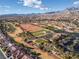 Panoramic aerial view of a community with a golf course and mountain backdrop at 3032 Bonnie Rock Dr, Las Vegas, NV 89134