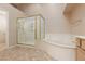 Bright bathroom featuring a glass-enclosed shower and a separate soaking tub at 3032 Bonnie Rock Dr, Las Vegas, NV 89134