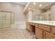 Primary bathroom suite featuring double sinks, glass-enclosed shower, and luxurious soaking tub at 3032 Bonnie Rock Dr, Las Vegas, NV 89134