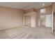 Spacious bedroom with neutral carpet, large closet, and entrance to the ensuite bathroom with tub and shower at 3032 Bonnie Rock Dr, Las Vegas, NV 89134