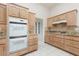 Gourmet kitchen featuring double ovens, custom cabinets, and granite countertops at 3032 Bonnie Rock Dr, Las Vegas, NV 89134