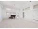 Spacious living room with neutral carpet, ample natural light, and a grand piano at 3032 Bonnie Rock Dr, Las Vegas, NV 89134