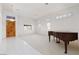 Inviting living room with neutral tones, a grand piano, and tiled entryway at 3032 Bonnie Rock Dr, Las Vegas, NV 89134