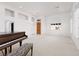 Open living area featuring neutral carpet, tiled floors, and natural light at 3032 Bonnie Rock Dr, Las Vegas, NV 89134