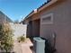 The backyard features an air conditioning unit, vegetation, and desert landscaping at 3401 Conan St # 103, Las Vegas, NV 89129