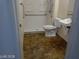 Bathroom featuring a walk-in shower, sink, toilet and grab bars at 3401 Conan St # 103, Las Vegas, NV 89129