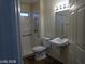Bathroom featuring a walk-in shower, sink, toilet and vanity mirror at 3401 Conan St # 103, Las Vegas, NV 89129